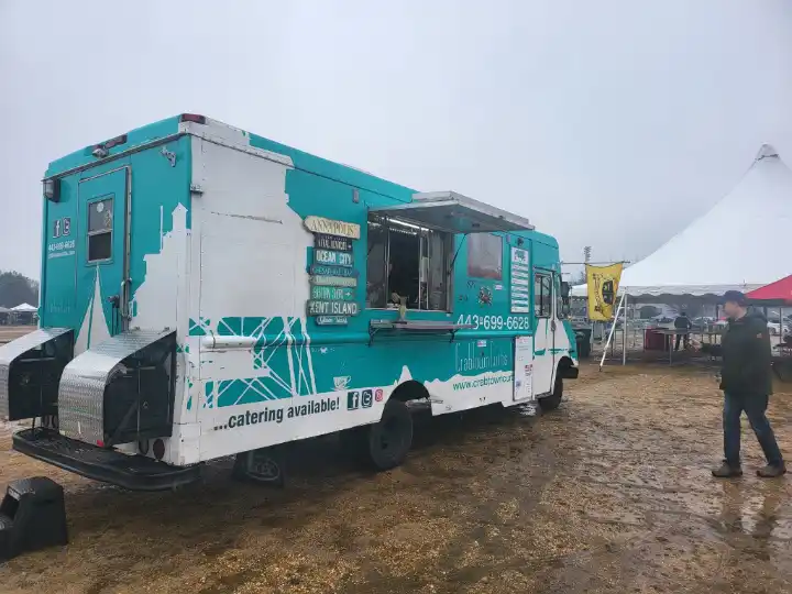 CrabTown Curbs food truck at an outdoor event with other tents and people nearby