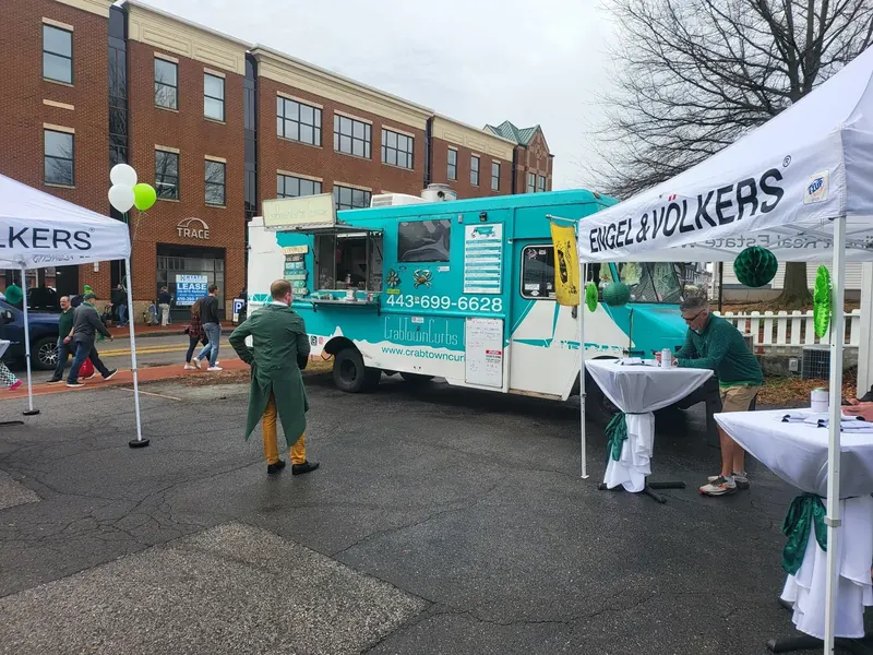 CrabTown Curbs truck serving beside event tents on parade day.