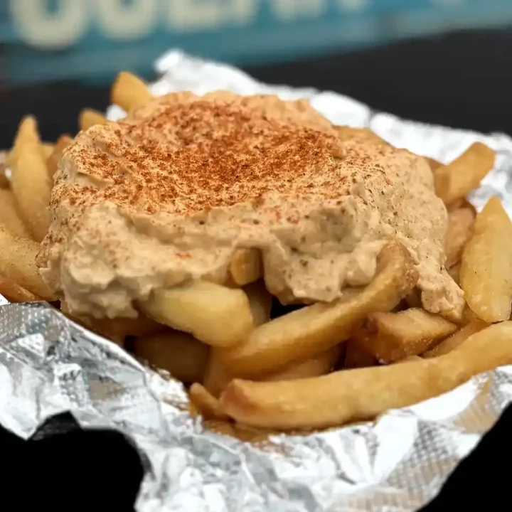 Crab dip smothered over hot French fries with Chesapeake crab spice.